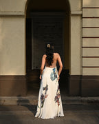 Simor Dessert Bloom Dress, a halter neck maxi dress with floral pattern and flowing fabric, perfect for summer occasions.