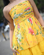 Simor Golden Hour tube layered short dress shown hanging on a mannequin with a flowy, layered design and vibrant golden color.