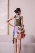 Simor Solistice High Neck Tiered Cascade Dress in flowing fabric with a high neckline and layered cascading design.