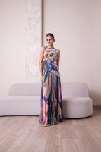 Abstract design maxi dress by Simor featuring a flowing silhouette and vibrant patterns on lightweight fabric.