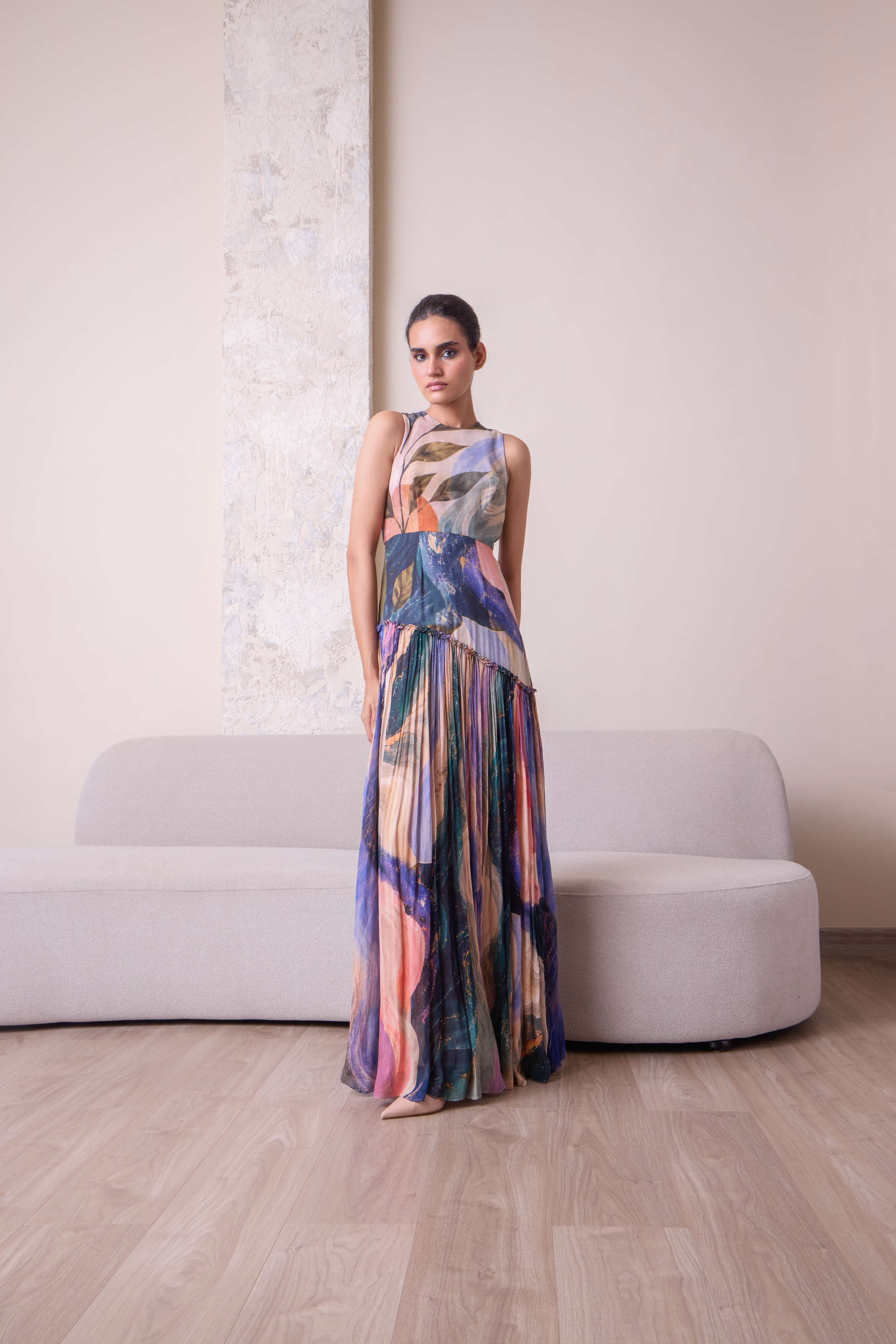 Abstract design maxi dress by Simor featuring a flowing silhouette and vibrant patterns on lightweight fabric.