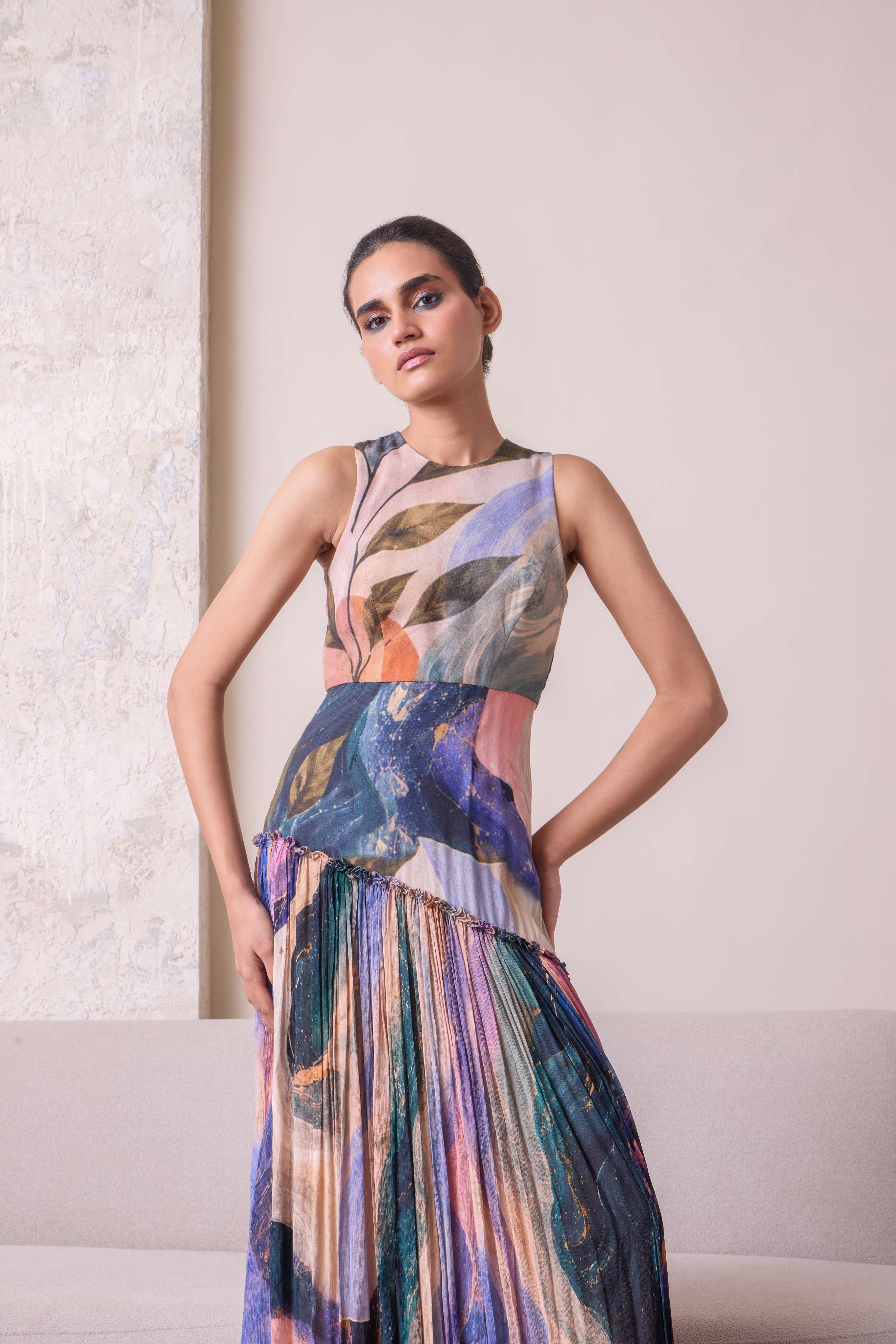 Abstract patterned maxi dress by Simor featuring a flowing silhouette and vibrant colors, displayed on a hanger.